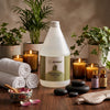 Globalstar-branded spa therapist applying Natural Massage Oil After Wax 2-in-1 to client's legs during professional after-wax treatment in luxury spa room