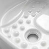 Close-up of a glossy white molded surface with raised circular bumps and a central circular opening, likely part of a product detail shot.