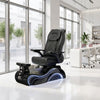 Black pedicure chair in a modern salon setting with large windows and white decor.