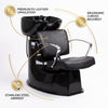 Female client relaxing in Globalstar 4014 shampoo chair while stylist washes hair in luxury gold salon setting