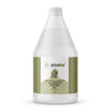 Globalstar Natural Massage Oil After Wax 2-in-1 3.78L in warm candlelit spa setting with lavender and sandalwood essential oils, hot stones, white towels and tropical plants