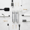 Butterfly Shadow hair spray makeup products with various hair styling tools on a marble surface