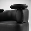 Female client seated in Globalstar MTS5 black leather manicure chair receiving nail treatment from technician in modern luxury salon