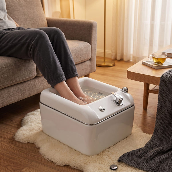 Person soaking feet in Globalstar T092 hydro-foot massage jacuzzi in cosy home living room setting