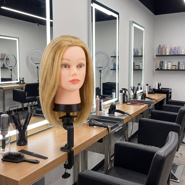 Globalstar 905 blonde mannequin training head on clamp mount displayed in professional salon floor setting with LED mirrors and styling stations